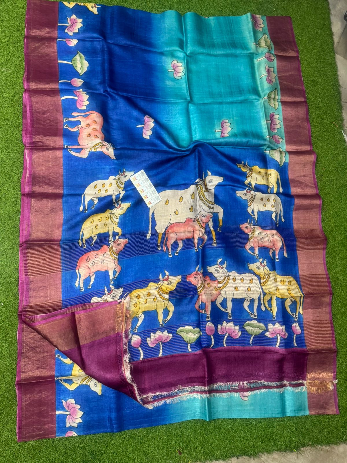 Blue handpainted Tussar silk saree with cow and lotus motifs and maroon border