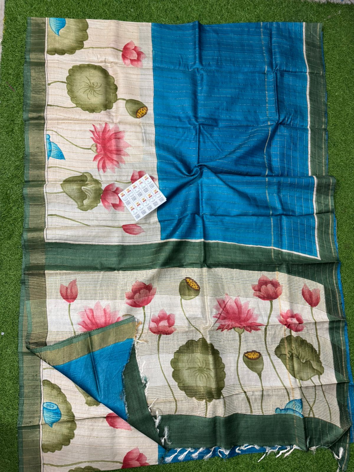 Blue and beige handpainted Tussar silk saree with lotus floral design and green border