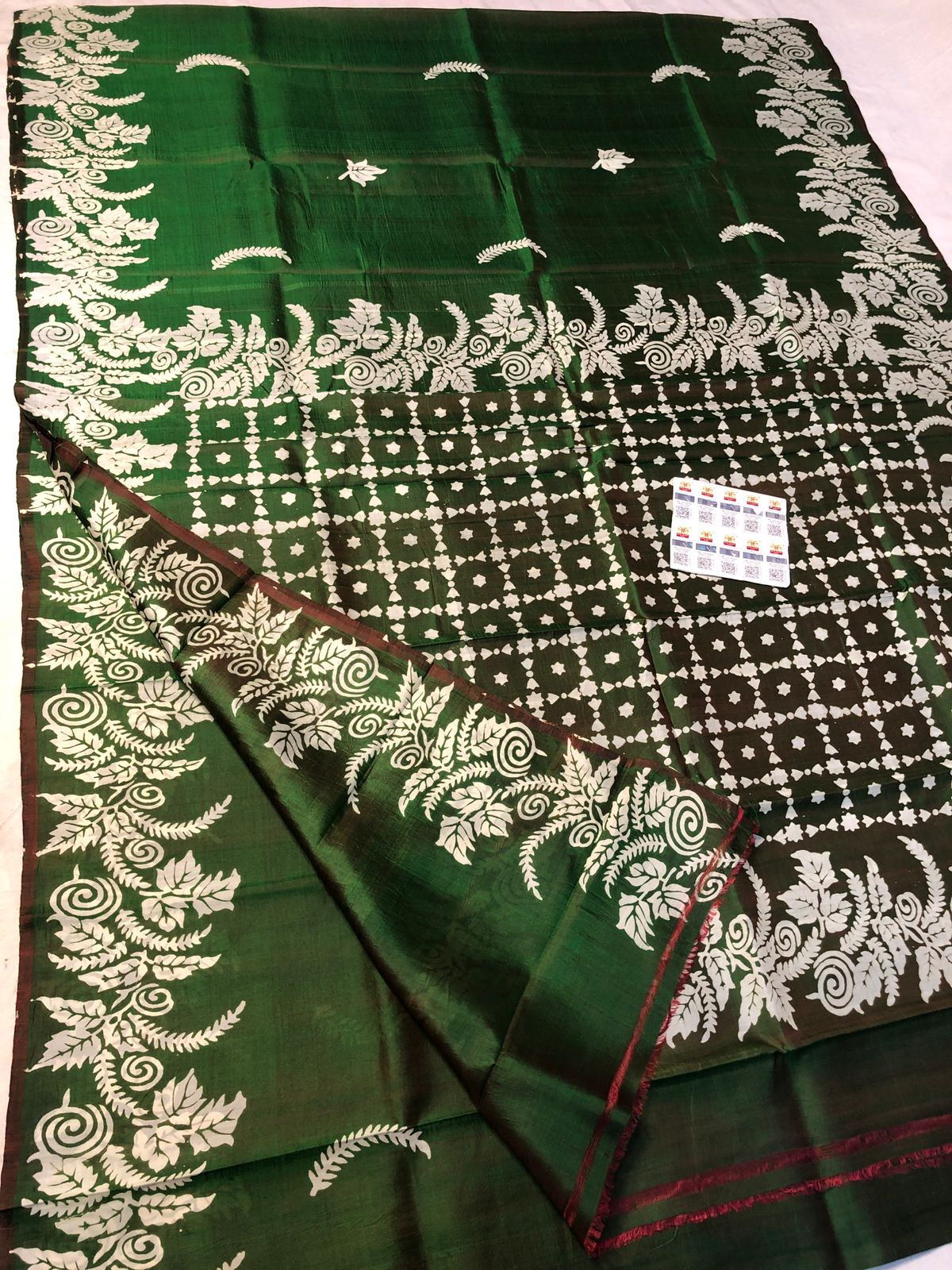 Dark green Katan silk saree with white floral and geometric traditional motifs