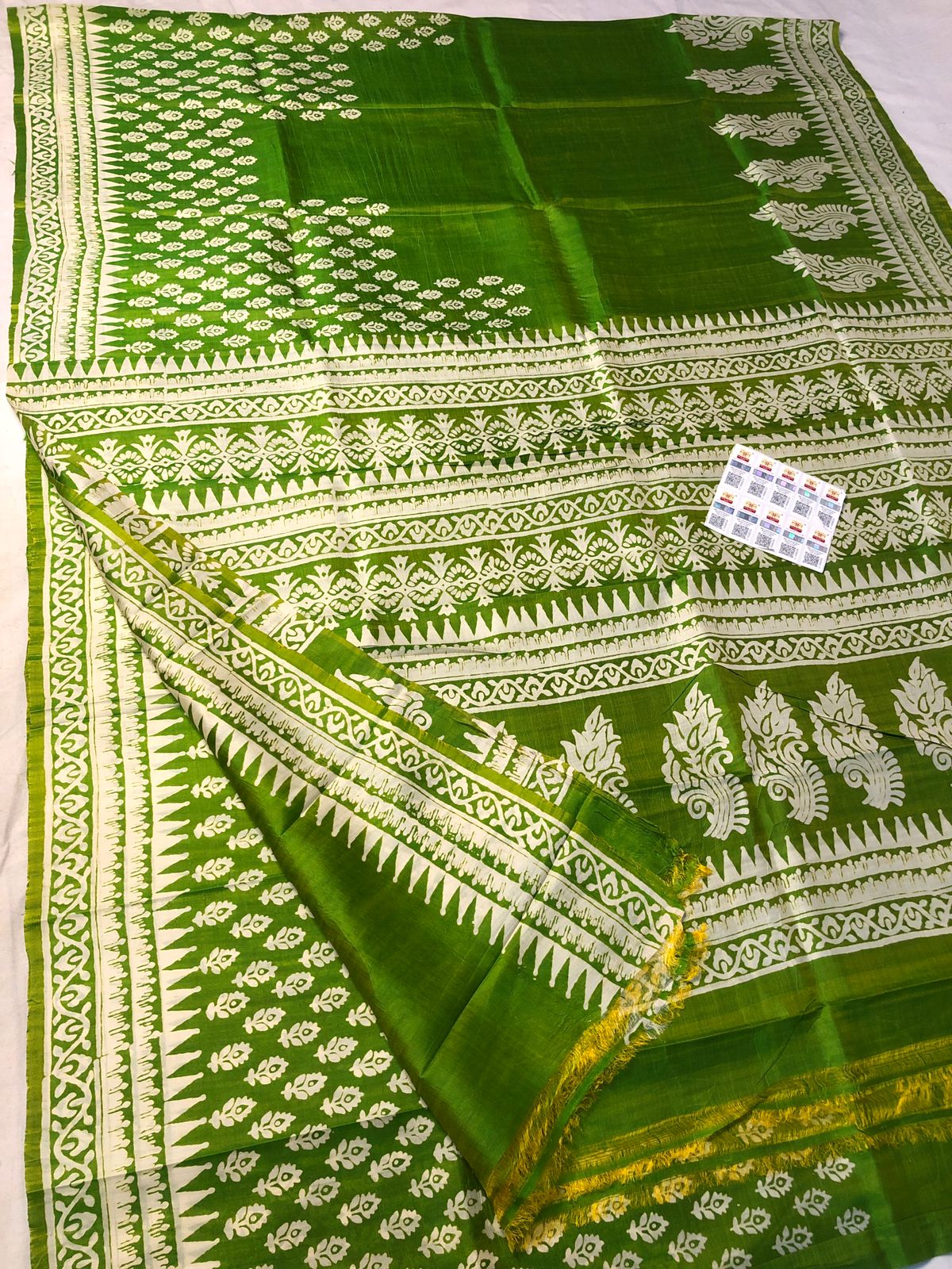 Bright green Katan silk saree with white traditional motif and detailed border design
